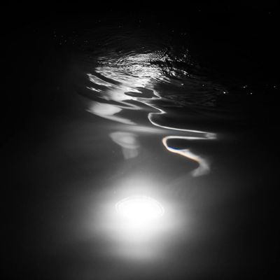 Abstract pattern of light reflecting on a calm water surface.