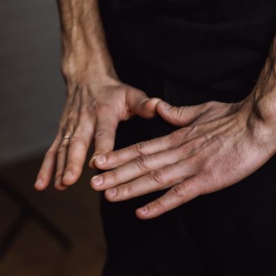Close-up of hands in a meditative mudra gesture.