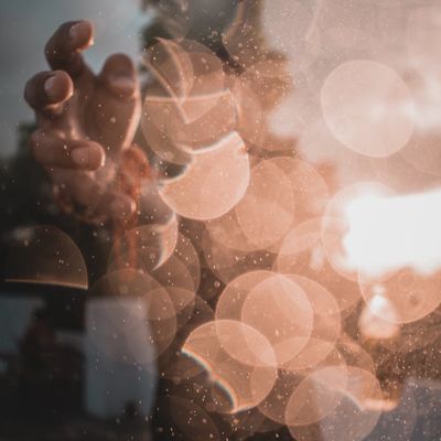 Silhouette of a person stretching against a soft background.